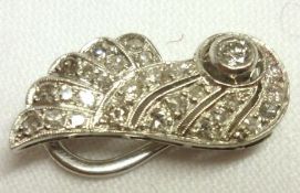 An unmarked precious metal Wing Design Clip, pavé set with twenty-seven Brilliant Cut small