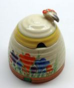 A Clarice Cliff Honeypot of ribbed spreading circular form, decorated in colours with a crocus