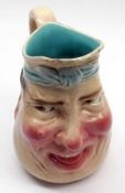 A Sarreguemines Humorous Majolica Style Jug, modelled as a grinning man and decorated in colours (