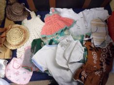 A small trunk containing a quantity of Vintage Dolls Clothes, Hats and Accessories