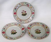 A set of three 18th Century Chinese Plates, the borders painted in colours with gilded ribbons and