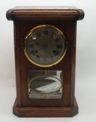 An early 20th Century Oak Mantel Clock of canted rectangular form, Roman numerals to a silvered