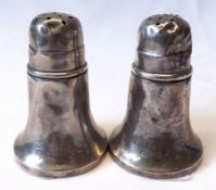 Two George V Pepper Casters, each of trumpet form with pierced and pull-off covers and composite