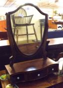 A 19th Century Mahogany Toilet Mirror with shield back over a serpentined base fitted with three