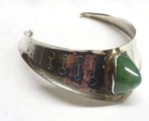 A foreign white metal and polished Jadeite stone set Collar of torc design