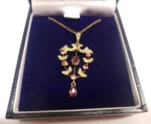 An Edwardian 9ct Gold Openwork Shield-shaped Pendant, set with Amethysts and Seed Pearls, stamped “