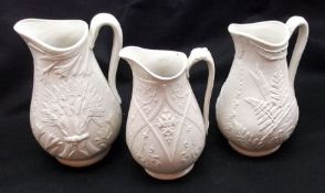 A Graduated Set of Three Victorian Jugs, each embossed with sheaves of wheat, the largest 9” high (