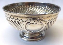 A George III circular pedestal small Sugar Bowl, later wrythen fluted and embossed, plain circular