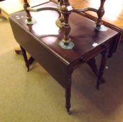 A 19th Century Mahogany Pembroke Table, fitted at each end with drawer and dummy drawer, raised on
