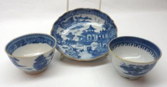 Two Chinese Export Tea Bowls and one Saucer, each decorated in under glazed blue with river