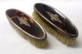 A pair of George V Child’s Clothes Brushes, oval shaped with inset Silver mounted Tortoiseshell