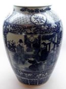 A large Oriental baluster Vase decorated in under glazed blue with panels of figures on foliate