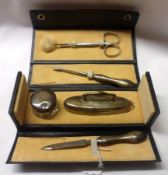A George V Leather Cased five piece Manicure Set (pair of Steel Scissors, three Silver mounted