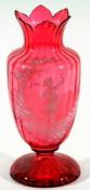 A Cranberry Glass large baluster Vase with a foliate rim, painted below in the manner of Mary