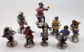A decorative Dresden eight piece Monkey Band, all painted in colours throughout on gilded scroll