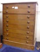 A Stained Pine Table Top Chest, fitted with eight drawers containing a collection of vintage