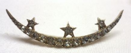 An Edwardian gilt metal and paste-set Crescent Brooch, with three star mounts to the curve,