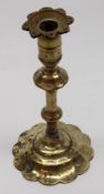 A Brass Candlestick with double knopped stem and spreading foliate base (repaired), 18th/19th
