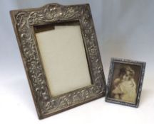 An Edward VII Silver mounted Photograph Frame, the embossed sides featuring masks, scrolls, birds,
