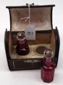 A late 19th Century Cased Scent Set comprising:  A Leather Box of domed rectangular form inset