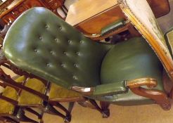 A Victorian Mahogany Green Leather Upholstered Spoon Back Armchair, splayed scrolled open arms