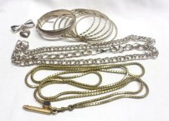 A packet of assorted Jewellery items including seven Bangles, Bow Brooch, Chains and Pencil