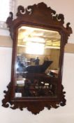 A Chippendale style Mahogany Wall Mirror with fretwork carved surround, 28” high