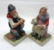 A pair of Staffordshire Figures of the Cobbler and his Wife, each painted in colours, on gilt