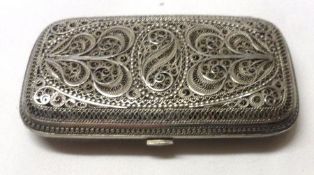 An Oriental white metal filigree work Card Case of shaped rectangular design, 3” x 1 ¾”