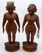 A pair of Eastern Carved Treen Primitive type Figures, 14 ½” high