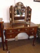A Georgian style Walnut Dressing Table of rectangular form, with moulded edge, crossbanded top
