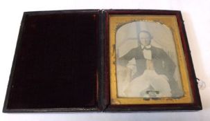 A Victorian folding Leather Cased Daguerreotype (Photograph) of a seated gent (defects to the