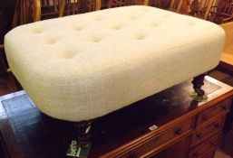 A decorative large Footstool upholstered in pale blue button back, raised on four balustered and