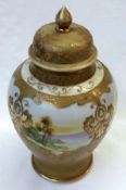 A Noritake Covered Baluster Vase, decorated in colours with panels of river scenes on a gilded