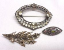 A packet containing a large openwork white metal Brooch, paste-set, stamped “935”, approximately 6cm
