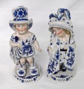 A pair of European Figures of Children, each with a naturalistic face and their clothing decorated