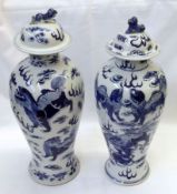 A near pair of Oriental Covered Vases of tulip baluster form, each painted in colours with Kaolin