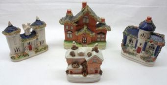 A collection of four various Staffordshire Cottages, all decorated in blue, salmon pink, etc,