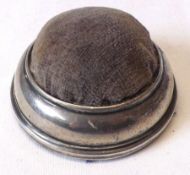 A Silver mounted small circular Pin Cushion, 2 ½” diameter, marks nearly erased