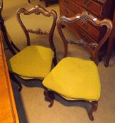 A set of four Victorian Rosewood Balloon Back Dining Chairs, with “C” scroll moulded backs and