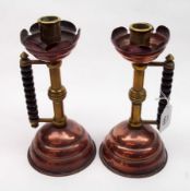 A pair of Arts & Crafts Copper, Brass and Treen handled Candlesticks, with stylised foliate sconces,