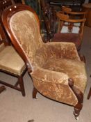 A 19th Century Mahogany Gents Armchair, upholstered in foliate patterned material, serpentined apron