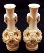 A pair of composition Spill Vases, the necks with moulded elephant mask handles above concentric