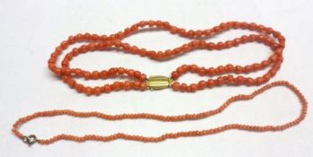 A double strand of graduated Pink Coral Beads with gilt metal snap; and a further smaller Pink Coral