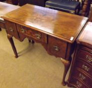 A Walnut Georgian style Low Bow, crossbanded top over three frieze drawers and raised on cabriole