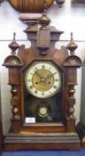 A late 19th Century Walnut Mantel Clock, the shaped case with moulded pediment surmounted by ring