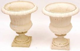A Good Pair of Victorian Cast Iron Campana-shaped Urns, moulded with foliage and on plain square
