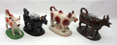 A probably Jackfield Black Glaze and Gilded Cow Creamer; a further Brown Glaze Cow Creamer (