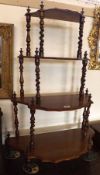 A Victorian Mahogany four tier Whatnot of shaped bow fronted form, with a central pierced fretwork
