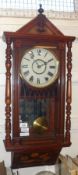 A late 19th Century Walnut Inlaid Wall Clock, the overhanging cornice surmounted by an arched